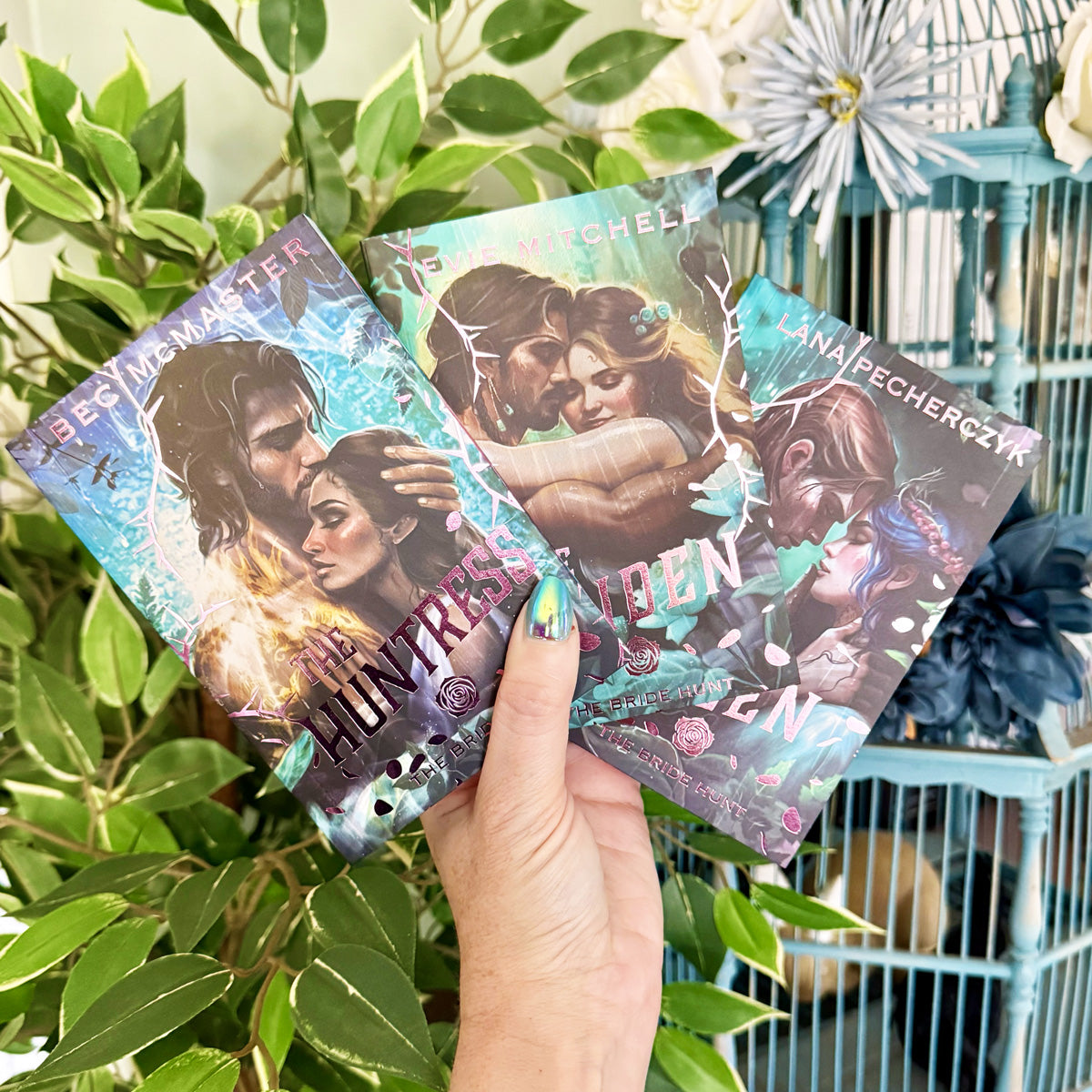 three foiled paperback books with illustrations of couples on the covers